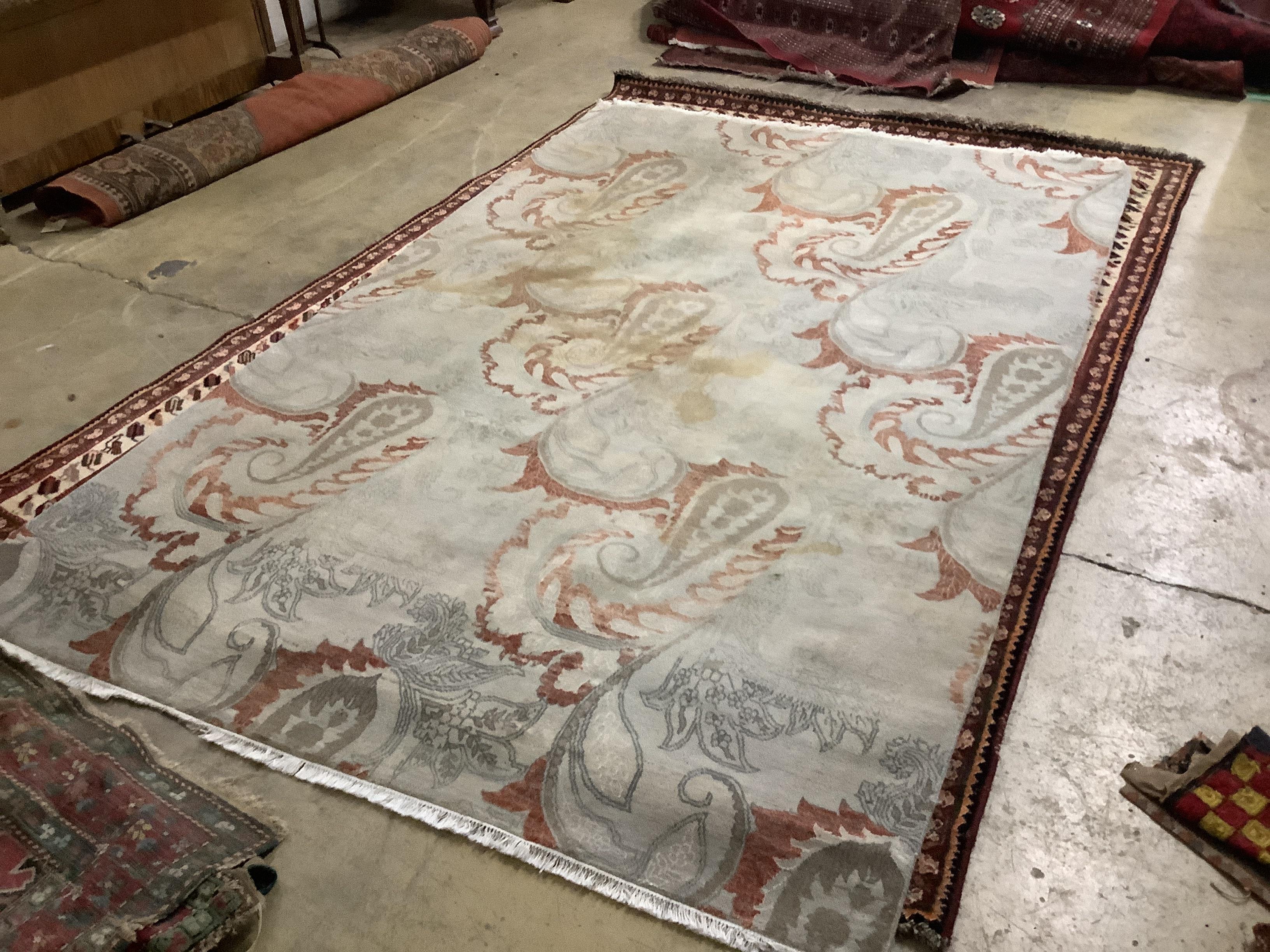 A handmade Oriental Emerald Paisley pattern carpet, retailed by The Rug Shop, Tunbridge Wells, 284 x 182cm
